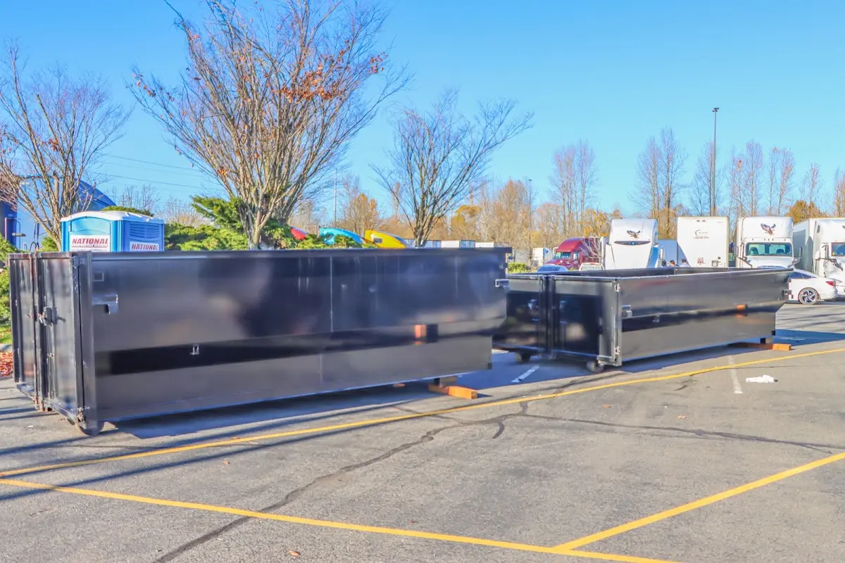 Professional dumpster rental service with roll-off container on residential driveway in Burley